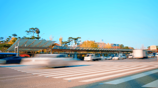 Busy road with cars and buses moving