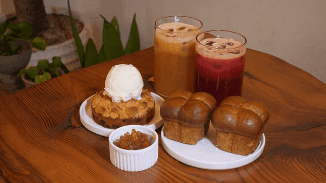 Cozy cafe table with drinks and desserts
