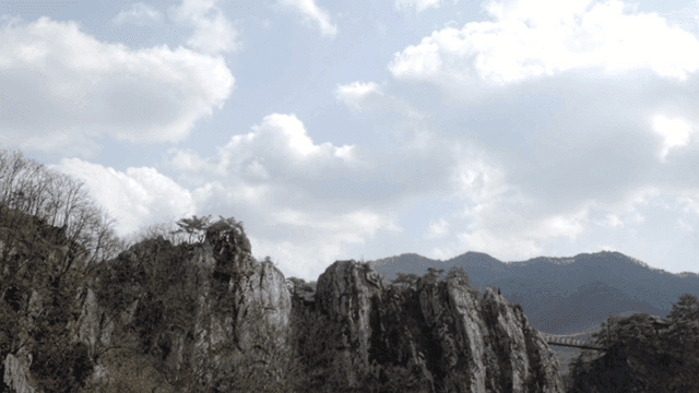 Rocky mountains under a cloudy sky