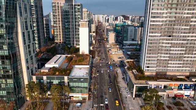 Bustling Urban Traffic Between Skyscrapers