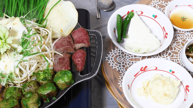 Korean barbecue with vegetables and side dishes