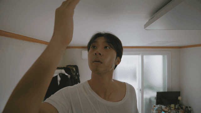 벌레를 잡은 손을 보는 남자