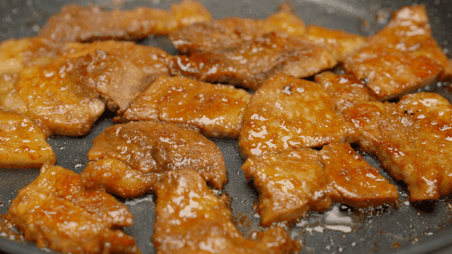 Sizzling marinated pork on a hot pan