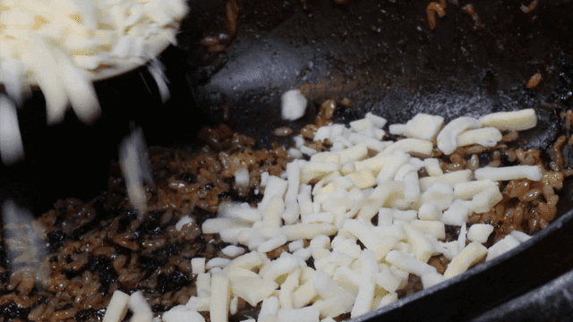 볶음밥 위에 치즈를 올리는 장면