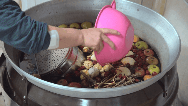 Herbs and fruits prepared in a cooking pot
