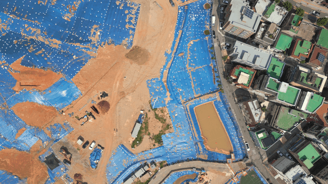 Construction site with blue tarpaulin