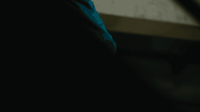 Prisoner in turquoise clothes coming down stairs