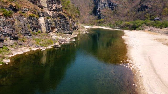 Tranquil river flowing between rocky cliffs