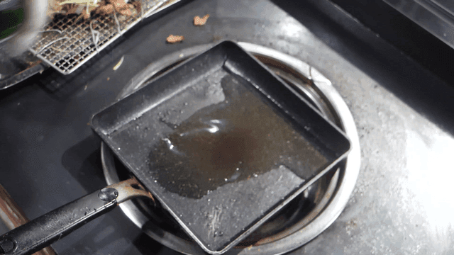Oil being poured into a heated pan