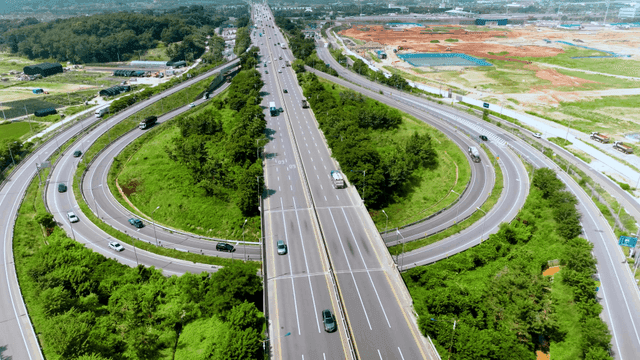 Aerial view of highway around green space