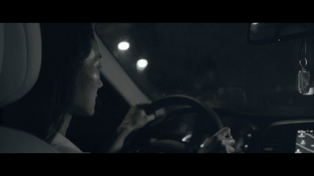 Woman driving at night