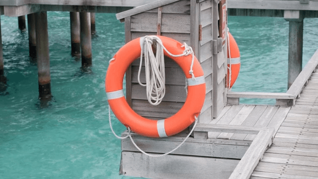 A lifebuoy on a wooden pier by the sea