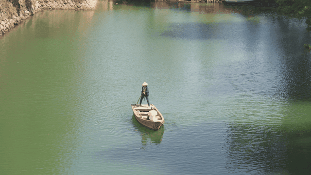 Boatman navigating a calm river