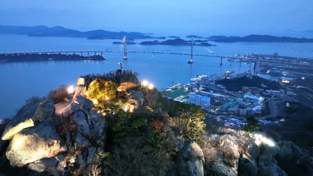 Scenic view of a bridge and city at dusk