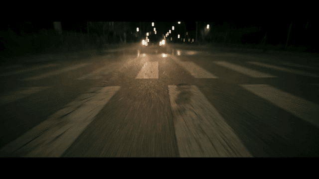 Nighttime road with a car approaching