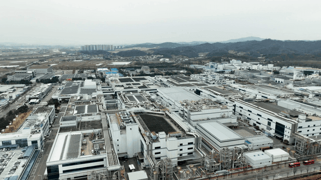 Large industrial complex with surrounding fields