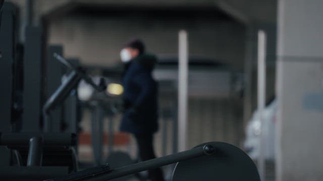 Person exercising on outdoor gym equipment