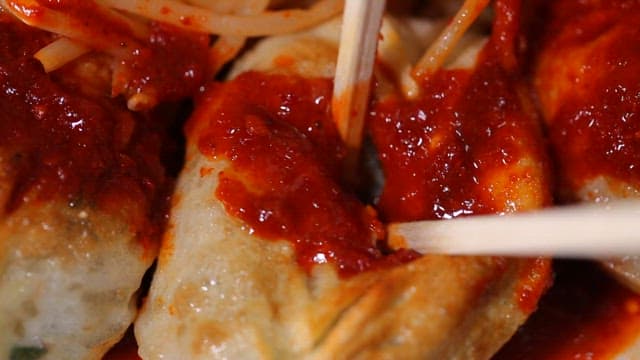 Spicy dumplings with red sauce