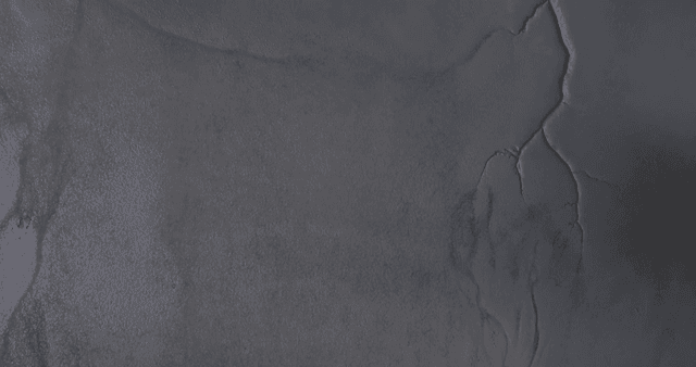 Aerial view of a snowy beach and boat