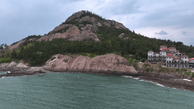 Coastal mountain with nearby village