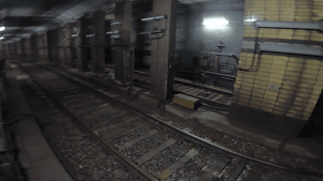 Subway tracks in a dimly lit tunnel