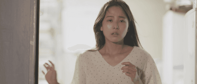 Surprised woman opening a door