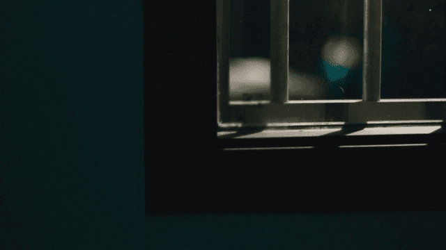 Prisoner being interrogated in dark room