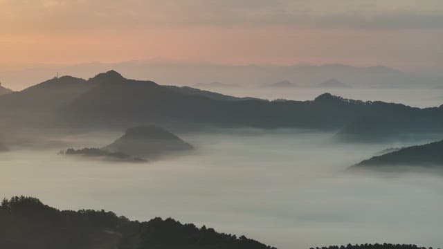 Sky Colored by Sunrise over Foggy Mountains