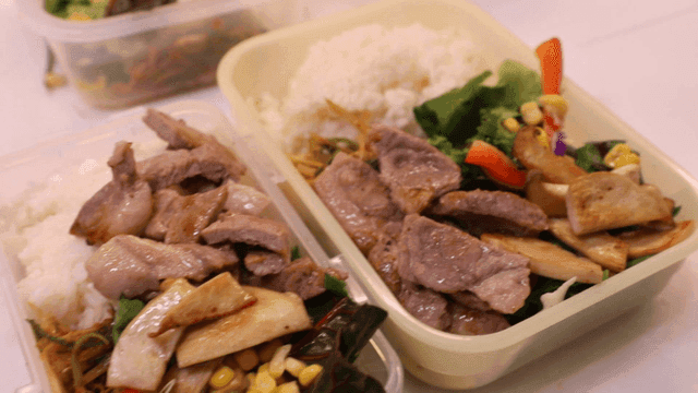 Lunchboxes with rice, meat, and vegetables