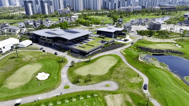 Modern golf course with clubhouse and greenery
