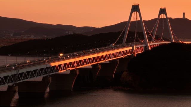 Bridge at sunset with cars passing by