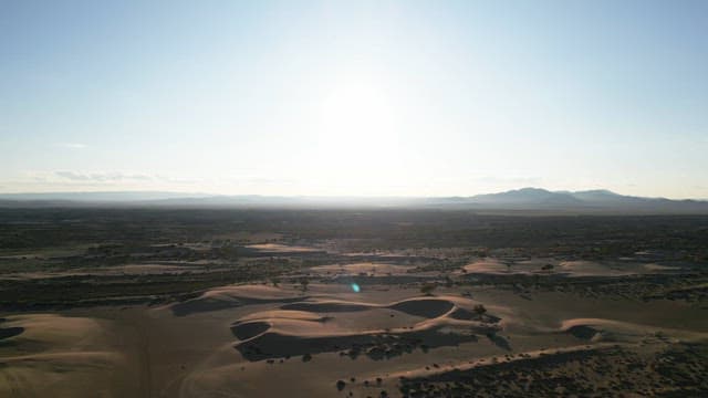 Vast desert landscape under bright sunlight