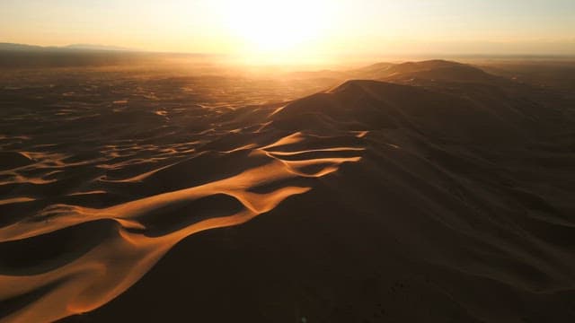 Golden sand dunes at sunrise