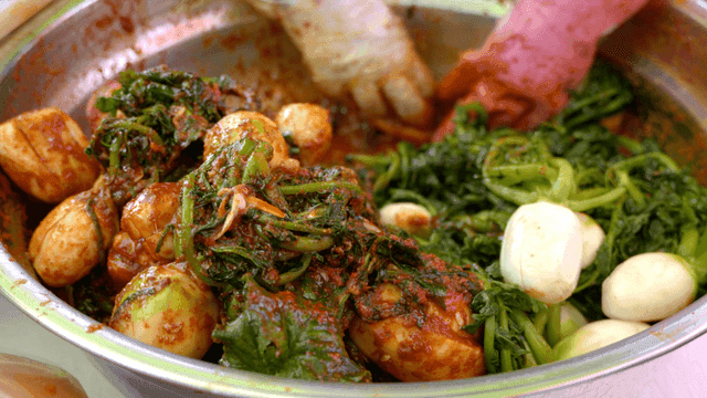 Mixing spicy kimchi seasoning with radish