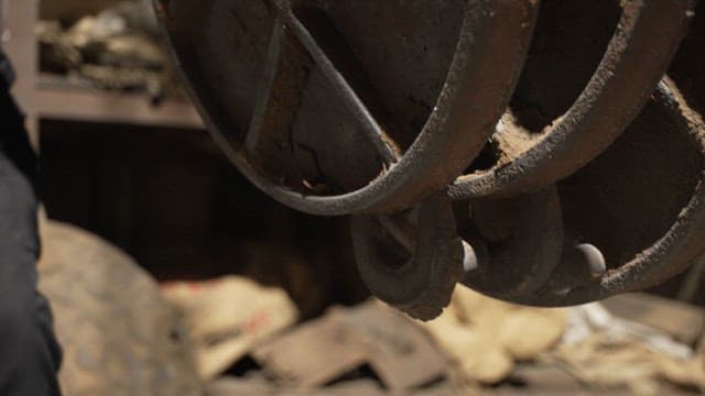 Worker handling heavy metal covers