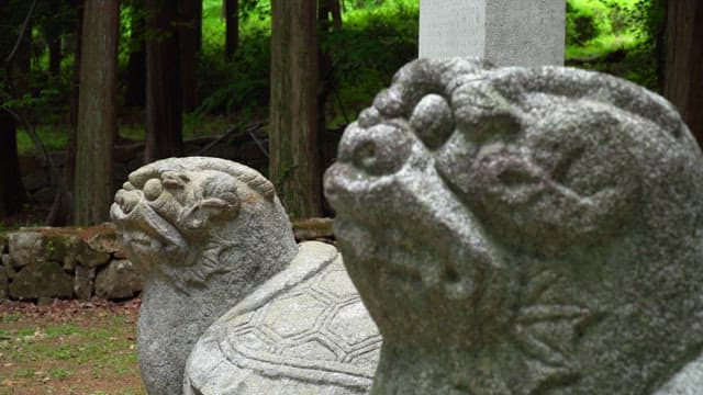 Stone carvings of animals in a quiet forest