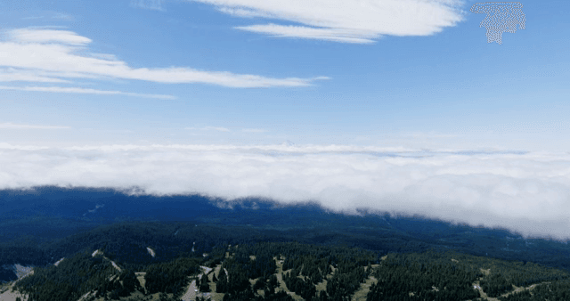 A vast mountain landscape with clouds