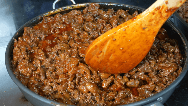 Cooking spicy beef dish in a large pot