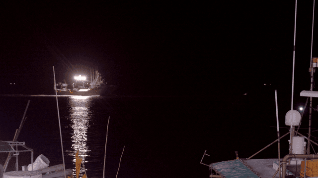 Fishing boat at night with bright lights