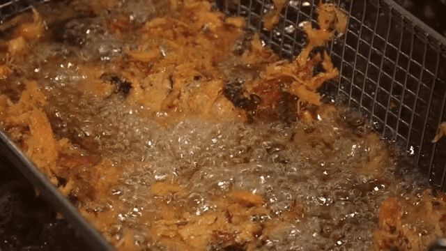 Deep frying Braised Pigs' Feet in hot oil