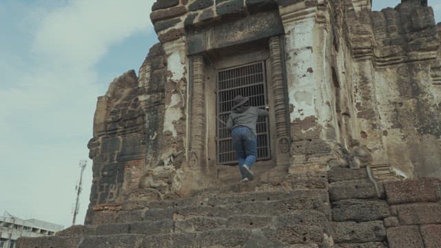 Person Training Monkeys in an Ancient Temple