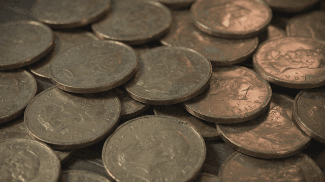 Pile of coins on wooden table