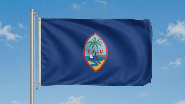 Guam flag waving against a blue sky