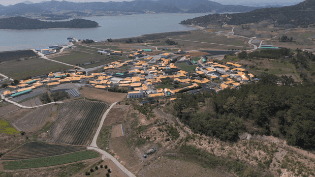 Rural village surrounded by fields and sea