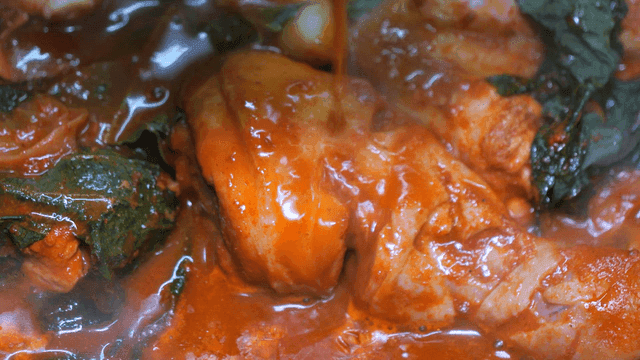 Spicy chicken stew boiling with vegetables
