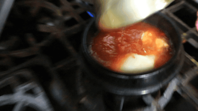 Soft bean curd jjigae being prepared in an hot pot