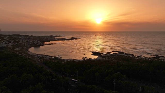 Sunset over a coastal town and ocean