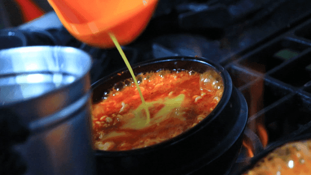 Adding egg to boiling soft bean curd jjigae