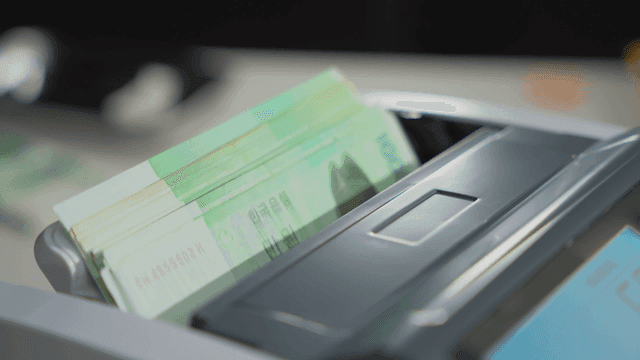 A money counting machine processing bills