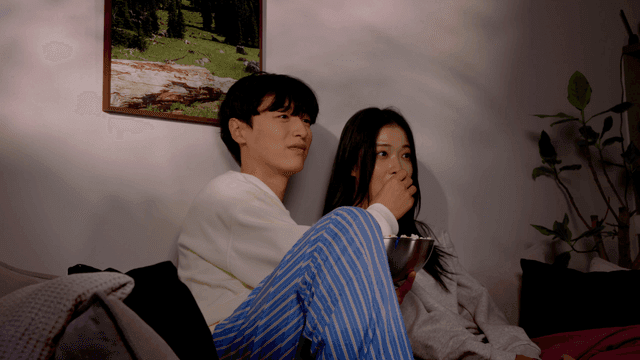 Couple enjoying a cozy movie night at home